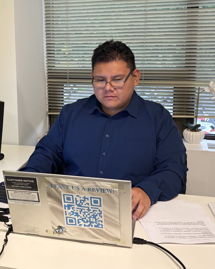 Renzo Vivar, Tax Preparer and Assistant Accountant, at his desk at Tax Delivery